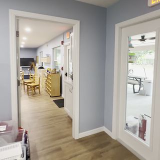 White casings around a doorway, with a plank floor running through.