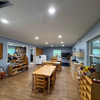 A long room with blue-gray painted walls and white baseboards.