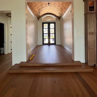 A foyer step wrapped in hardwood with a rounded nosing on the edge.