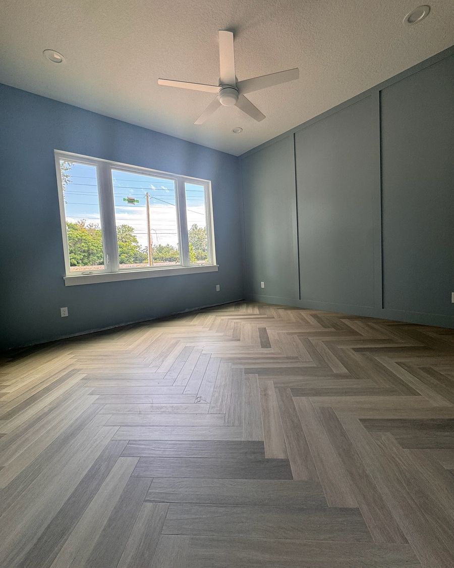 The same bedroom when done, with a gray herringbone floor.