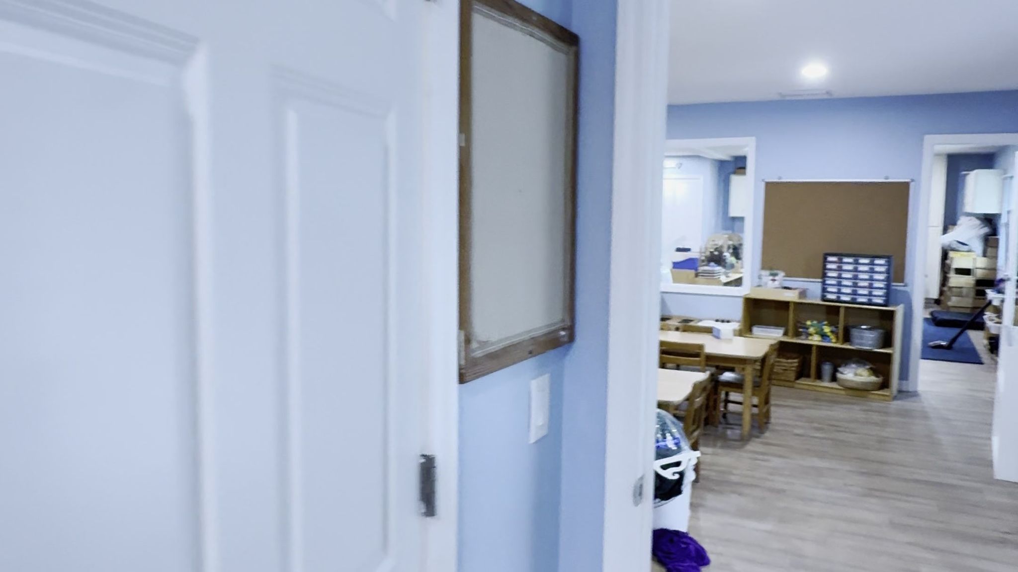 A six-panel white interior door with new casing next to a hallway.