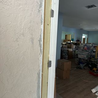 A new interior door jamb set into a textured wall.