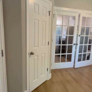 A six-panel interior door and a pair of glass-paneled interior doors.