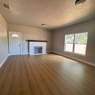 A living room with smooth painted walls and a new floor.